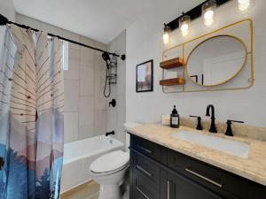 a bathroom with a sink and a toilet and a mirror at Boulder Apache Junction in Apache Junction
