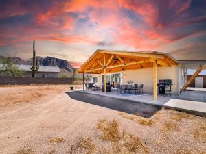 a house with a porch with a table and a grill at Boulder Apache Junction in Apache Junction