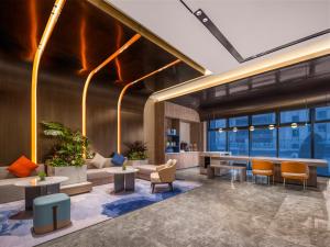 a lobby of a building with tables and chairs at Holiday Inn Express Changzhou Henglin by IHG in Changzhou +45 photos
