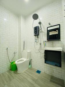 a bathroom with a toilet and a sink at Arissa HomeStay in Kampong Bukit Katil