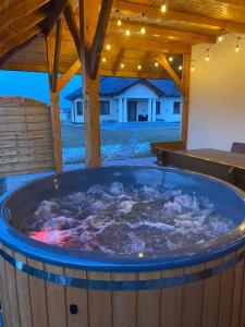 a hot tub in the middle of a yard at Dworek pod Krzyżtoporem Ujazd Agroturystyka- pokoje do wynajęcia in Iwaniska