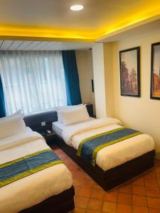 Letto o letti in una camera di Harsha Boutique Hotel