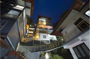 a view of a building at night with a staircase at Lazo Golden Valley Resort , Munnar in Munnar