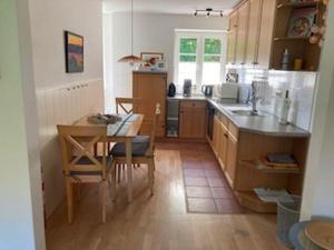 a kitchen with a table and a table and a dining room at Ferienwohnung Ingrid in Langballig