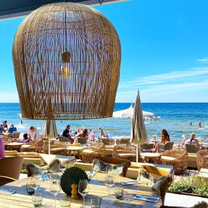 a restaurant with tables and chairs on the beach at Tofta Resort in Tofta +4 photos