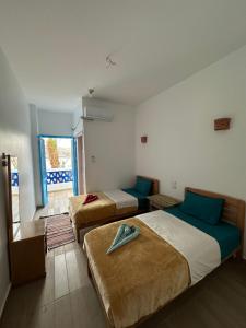 Postel nebo postele na pokoji v ubytování Palm Geust House + 37 fotografií