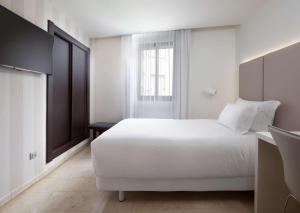 Cama ou camas em um quarto em NH Ciudad de Santander