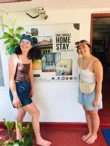 two women are standing in front of a store at Cafe Tangola Home Stay in Tangalle
