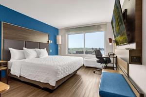 a hotel room with a bed and a window at Tru By Hilton Colorado Springs Airport in Colorado Springs