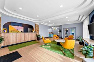 a lobby with yellow chairs and a table at Spark By Hilton San Antonio Near Seaworld in San Antonio