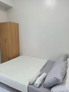 a bed with pillows on it in a bedroom at Mivela Residences in Cebu City +10 photos