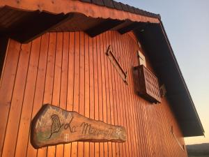 a sign on the side of a red building at Gîte de France La petite marmotte in Saint-Béron