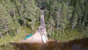 an aerial view of a house and two boats on a river at Riverside cabin Hiekkaranta in Kuusamo
