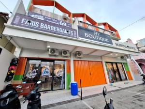 a store front with a sign for a motorcycle dealership at Koala Tidur Hostel Syariah Yogyakarta in Seturan