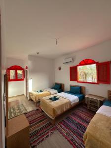 Postel nebo postele na pokoji v ubytování Palm Guest House