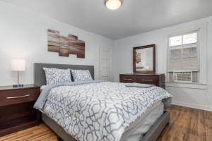a white bedroom with a bed and a window at Somerset 2 in Ocean City