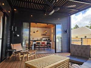 a patio with a table and chairs on a deck at W Villa 8 Kundasang in Kampong Kundassan