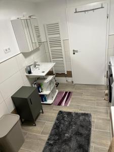 a bathroom with a sink and a toilet and a door at TOP Wohnung in Volkach A3 Ausfahrt Top Service in Volkach +11 photos