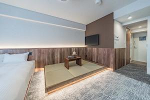 a hotel room with a bed and a table at Apartment Hotel 11 Kuromon 4 in Osaka +35 photos