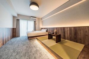 a hotel room with a bed and a window at Apartment Hotel 11 Kuromon 4 in Osaka