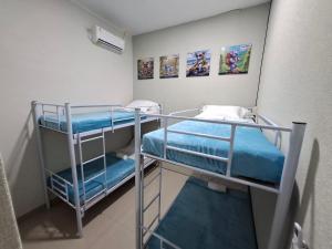a small room with two bunk beds in it at Koala Tidur Hostel Syariah Yogyakarta in Seturan +24 photos