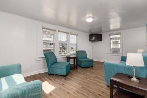 a waiting room with blue chairs and a table and windows at Somerset 4 in Ocean City