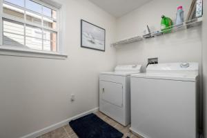a laundry room with a washer and dryer and a window at Sandy Pause 803B in Ocean City +12 photos