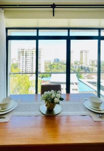 a table with a vase of flowers on top of it at Silverstone Apartments Nairobi, Kilimani in Nairobi