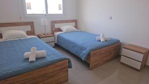 a bedroom with two beds with crosses on them at Obv 3-206 in Pyla