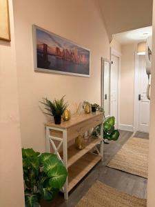 a living room with a table and a picture on the wall at Luxe city stay in Ipswich