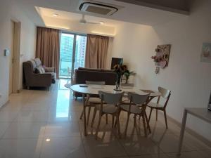 a living room with a table and chairs at Luxury Balcony Suites- Homestay in Kuala Lumpur