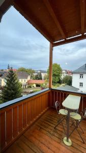 a patio with a table and chairs on a deck at Apartment-Luck Ilmenau in Ilmenau
