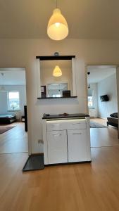 an empty living room with a white cabinet and a mirror at Apartment-Luck Ilmenau in Ilmenau