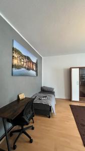 a bedroom with a bed and a desk in it at Apartment-Luck Ilmenau in Ilmenau