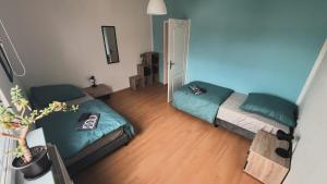 a small room with two beds and a mirror at Apartment-Luck Ilmenau in Ilmenau