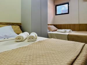 ein Hotelzimmer mit zwei Betten mit Handtüchern darauf in der Unterkunft Flat Aquaville perto do Beachpark com 3 Suites in Aquiraz + 52 Fotos