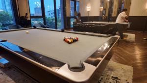 a pool table with balls on it in a room at Luxury Riverside Private Condo Bangkok North Area in Ban Sai Ma