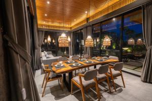 a dining room with a wooden table and chairs at Villa Mama 1 Ubud in Ubud