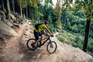 a man riding a bike on a dirt road at Elements Hotel&Spa in Świeradów-Zdrój
