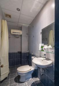 a bathroom with a toilet and a sink at Purple Hue - Charming Riverside in Hue +41 photos