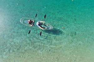 a person laying on a surfboard in the water at KAMENOI HOTEL Kochi in Ino +75 photos