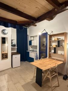 a dining room with a wooden table in a room at Casa Carlotta in Rio nellʼElba