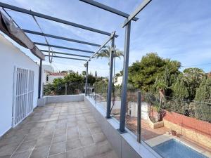 an outdoor patio with a swimming pool and a fence at VILLA T11 PREMIUM 5min PLAYA in El Campello
