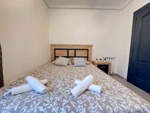 a bedroom with a bed with two pillows on it at VILLA T11 PREMIUM 5min PLAYA in El Campello +45 photos