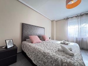 a bedroom with a large bed with pink pillows at VILLA San Juan PLAYA Alicante in El Campello +23 photos