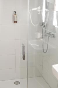 a shower with a glass door next to a sink at Casa BACCO in Rotenburg an der Fulda +84 photos