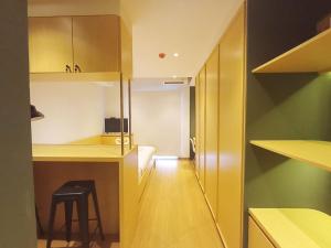 a small kitchen with a stool in a room at Comfy and Best Deal Studio at Mataram City Apartment By Travelio in Kejayan +10 photos