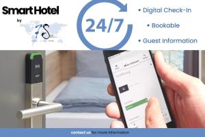 a person holding a cell phone in front of a bed at 7Seas City-Apartment Kaiserslautern - Balkon l NETFLIX l 24h Self Check-in in Kaiserslautern