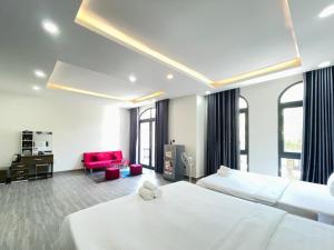 una camera d'albergo con due letti e una scrivania di Katie Homestay a Phu Quoc Altre 63 foto