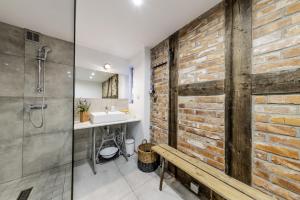a bathroom with a brick wall and a sink at Blossom Hill Apartments in Łęcze +93 photos